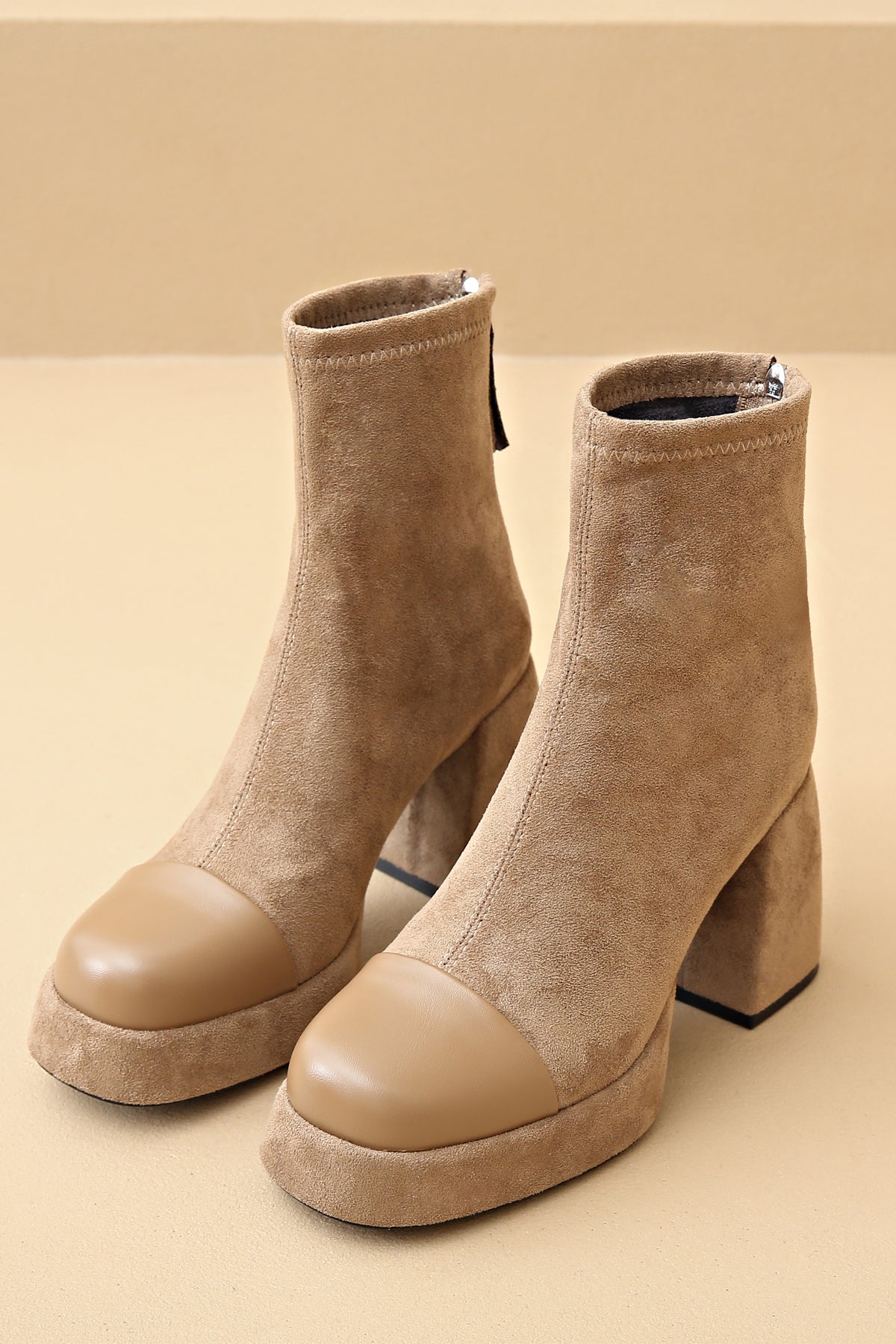 Elegant beige suede ankle boots with leather front design